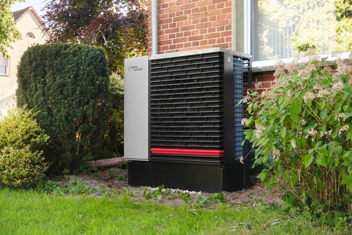 Energiezuinige warmtepomp buitenunit in de tuin van een woning in Tilburg